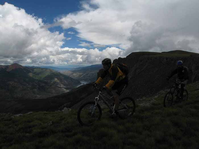 Hans and Ed, riding through the saddle with Lake San Cristobal below